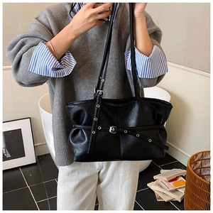 Vue détaillée du sac cabas en similicuir noir avec boucles et texture plissée
