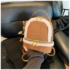 Detail of brown suede mini backpack with white fleece trim and gold-tone double zippers