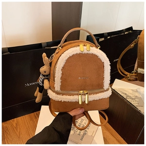 Brown suede mini backpack with white faux fur trim and cute rabbit doll keychain charm