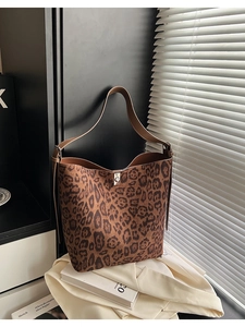 Macro detail of leopard print tote bag featuring suede texture and silver metal lock