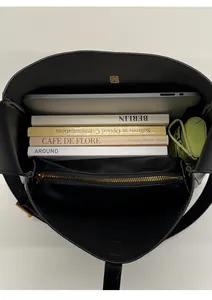 Top view of black leather tote bag interior showing large capacity for laptop and books