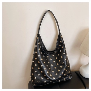 Detail of black vintage hobo bag featuring silver rivet studs on textured leather