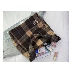 Spacious interior of plaid tote bag showing capacity for iPad, wallet and daily items