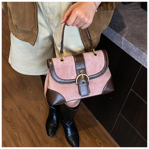 Detailed texture of pink suede and brown leather patchwork on vintage retro satchel bag