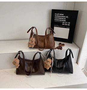 Detailed view of three vintage PU leather shoulder bags in brown, coffee, and black tones