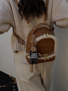 Brown suede mini backpack with white faux shearling trim and cute plush rabbit keychain
