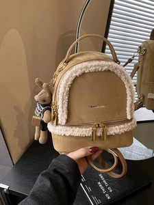 Brown faux suede backpack with white fleece trim and cute bunny charm for daily travel