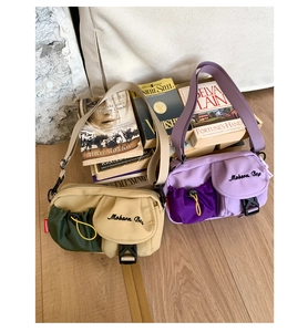 Detail view of retro functional crossbody bags in khaki and purple nylon fabric