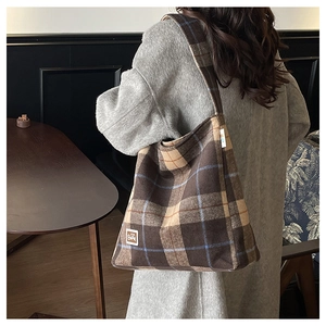 Detailed close-up of the vintage plaid tote bag with fuzzy texture and Bear logo patch