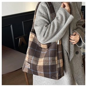 Detailed close-up of large-capacity checkered wool tote bag with classic weave pattern
