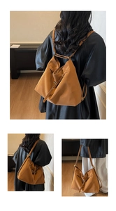 Detail view of earth-tone leather tote bag showing multiple ways to wear and carry