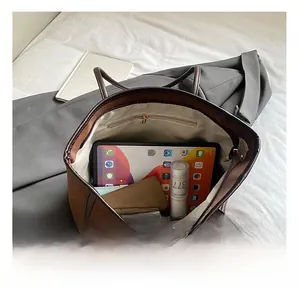 Top-down macro view of large tote bag interior showing spacious capacity and zipper pocket