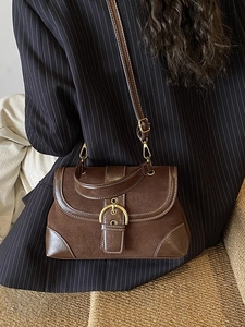 Retro dark brown underarm bag with contrast stitching and golden buckle on model