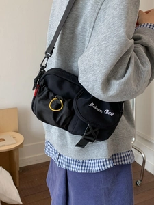 Black vintage nylon crossbody messenger bag with buckle and yellow drawstring detail
