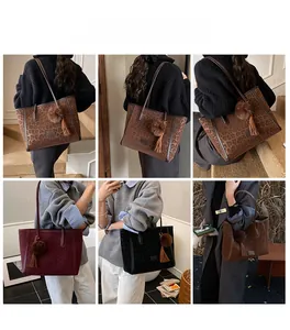Detailed model views of leopard print tote bag with plush pom-pom and tassel charms