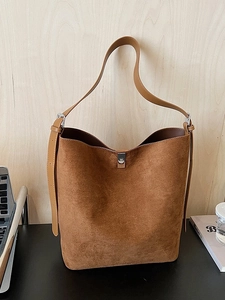 Retro brown suede bucket bag with adjustable leather strap and silver metal twist lock