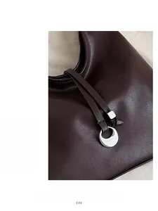 Detailed macro view of silver crescent metal buckle and dark brown leather texture
