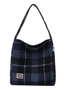 Navy blue and black checkered flannel tote bag with embroidered bear patch in a casual style