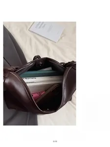 Spacious interior of dark brown tote bag showing capacity for books and daily essentials
