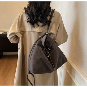 Detailed view of large vintage tote bag with unique geometric fold design on model
