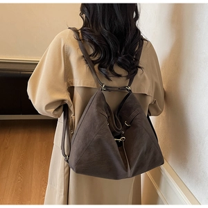 Detail view of large dark brown tote bag with metal rings and soft matte leather texture