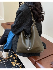 Detail of olive green hobo tote bag featuring a minimalist knot strap and silver buckle