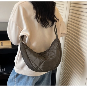 Quilted crescent nylon shoulder bag in olive green showing spacious hobo design with zip