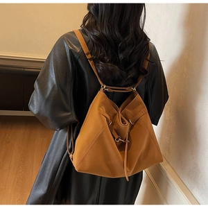Detail of vintage large brown leather shoulder bag with drawstring and soft pleats