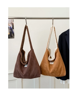 Detail of large tote bags in brown and camel faux suede with soft shearling lining