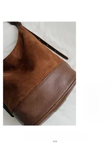 Detailed close-up of caramel brown shoulder bag showing suede and smooth leather texture