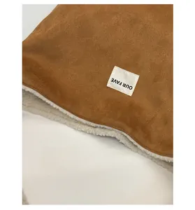 Detail of the suede tote bag with warm lamb wool lining and the OUR FAVE woven label