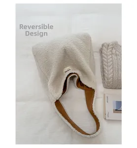 Detail view of double-sided fleece tote bag in beige and brown with letter patch
