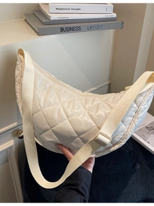 Off-white quilted nylon hobo bag with adjustable wide shoulder strap and crossbody design