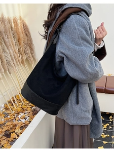 Suede and leather shoulder bag shown on model in an outdoor autumn setting