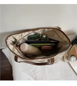 Close-up of spacious quilted tote bag interior with multiple compartments and pockets