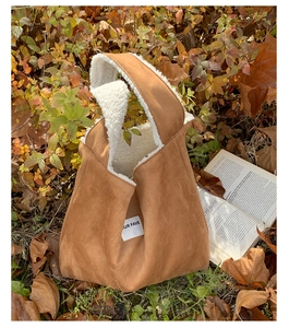 Detailed close-up of brown suede tote bag with white fleece lining and UR FAVE label