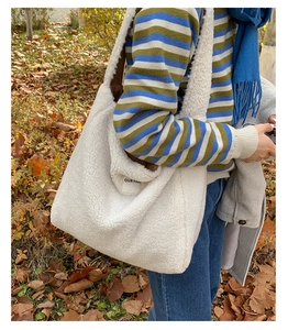 Detail of white sherpa tote bag with Our Favs label and fuzzy fleece texture