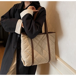Quilted beige tote bag with brown leather trim shown on model for daily casual outfit