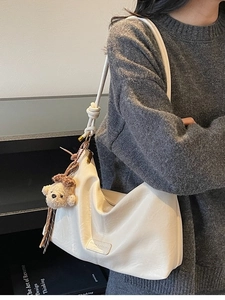 White vintage faux leather tote bag with shoulder strap and plush bear charm for women