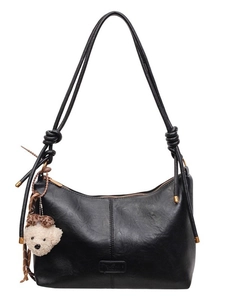 Minimalist black PU leather tote bag with round cord handles and bear plush pendant
