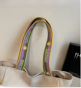 Detailed shot of the colorful woven straps and canvas texture of the large tote bag