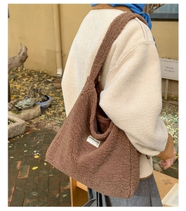 Detailed view of brown plush fleece tote bag with OUR FAVE label on shoulder