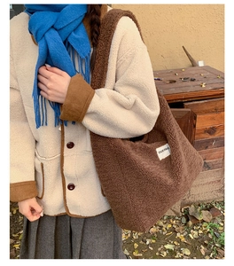 Close-up of brown faux shearling tote bag featuring a minimalist OUR FAVE fabric patch