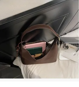 Detail view of large capacity dark brown hobo bag interior with tablet and essentials