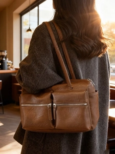 Brown vintage faux leather shoulder bag with dual front zippers and side pocket detail