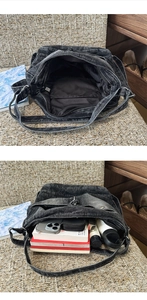 Detail view of denim crossbody bag interior capacity with books and phone