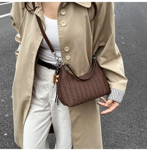 Detail of vintage brown pleated faux leather shoulder bag with decorative wooden beads