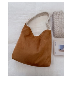 Detail of brown tote bag with white fleece lining and soft suede texture in flat lay
