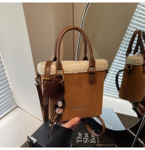 Détail du sac seau en daim avec bordure en peau de mouton et breloque peluche