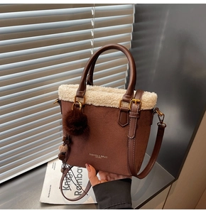 Gros plan d'un sac cabas en daim marron avec bordure en peau de mouton et texte doré